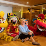 Victoria Mekong Cruises guest enjoying a festive lion dance performance on board