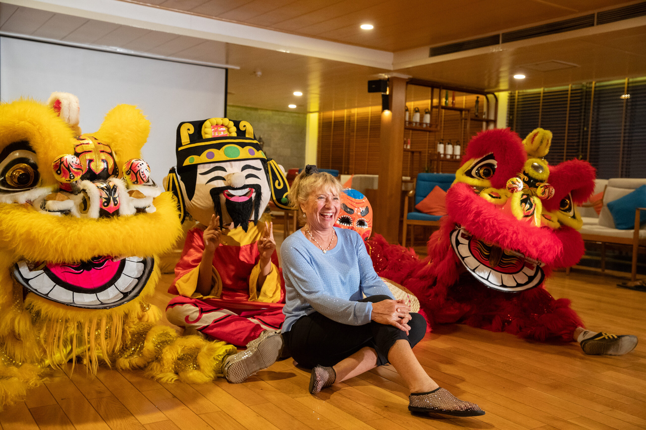 Victoria Mekong Cruises guest enjoying a festive lion dance performance on board
